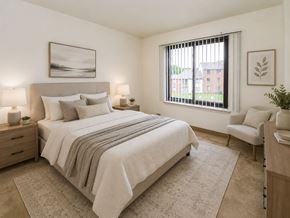 East Brunswick apartment for rent - A bedroom with a large bed and a chair.