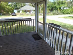 Sarasota house for rent - A spacious room with a ceiling fan and wooden flooring.