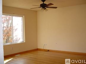 Kalamazoo house for rent - Empty room with a ceiling fan and a window.