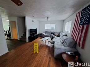 Kalamazoo house for rent - A living room with a yellow caution sign on the floor.