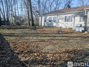 Kalamazoo house for rent - A house with a lawn and trees in the background.