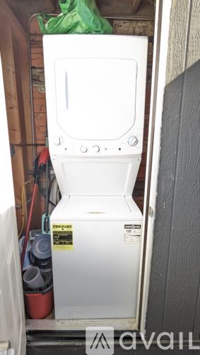San Diego apartment for rent - A white toilet is in a small space with a green bag in the background.