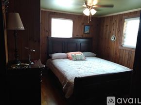 Ronda house for rent - A bedroom with a bed, nightstand, lamp, and a window.