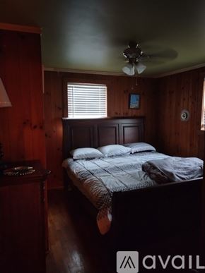 Ronda house for rent - A bedroom with a bed, nightstand, and window.