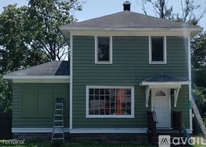 Kalamazoo house for rent - A green house with a white door and windows.