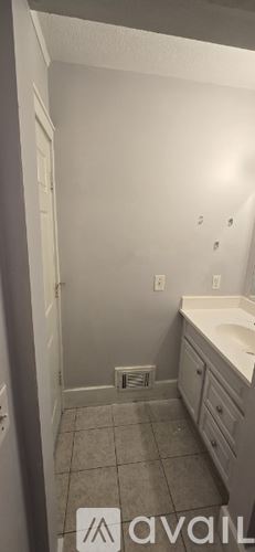 Kalamazoo house for rent - A bathroom with a white sink and a white door.