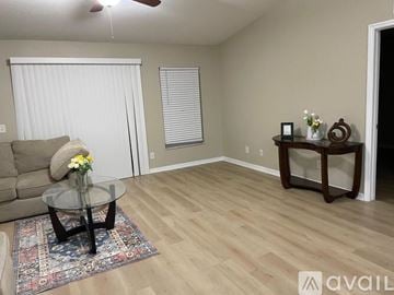 Lakeland house for rent - A living room with a glass coffee table and a couch.