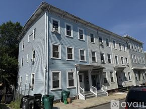 Boston apartment for rent - A row of houses with blue and white siding.