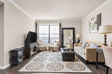 Creve Coeur apartment for rent - A living room with a large rug and a flat screen TV.