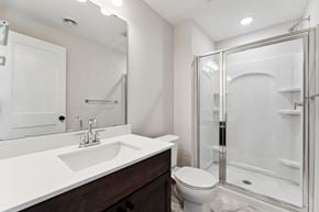 Woodbury house for rent - A white sink with a silver faucet and a white toilet in a bathroom.