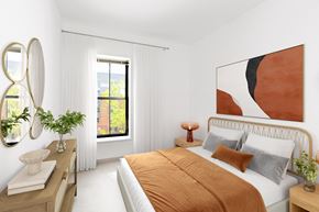 Boston apartment for rent - a bedroom with white walls and a bed with orange pillows