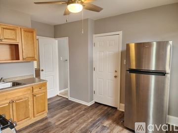 Bridgeport apartment for rent - A kitchen with wooden cabinets and a stainless steel refrigerator.
