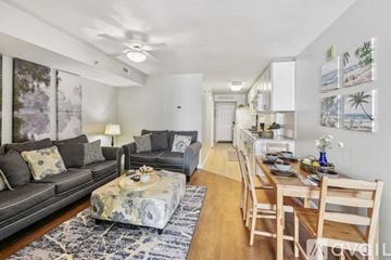 North Myrtle Beach house for rent - A living room with a grey couch and a coffee table with a floral pattern.