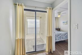 North Myrtle Beach house for rent - A bedroom with a bed and a sliding glass door leading to a balcony.