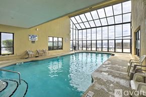 North Myrtle Beach house for rent - A pool with a glass ceiling and chairs around it.