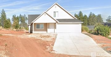 Paradise house for rent - A house with a white garage door is for sale.