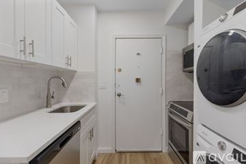 Boston apartment for rent - A white kitchen with a sink, dishwasher, and oven.