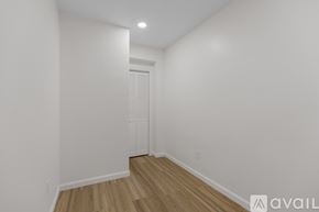 Boston apartment for rent - A room with a wooden floor and white walls, with a door in the background.