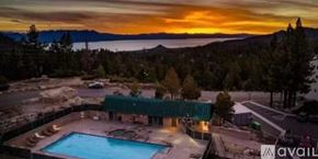 Stateline condo for rent - A beautiful sunset view of a pool and a house with a mountain in the background.