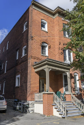 Ottawa apartment for rent - A red brick building with a white door and windows.