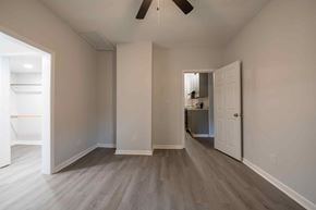 Fayetteville house for rent - A room with a ceiling fan and light, and a doorway leading to another room.