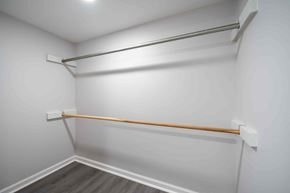 Fayetteville house for rent - A white wall with a wooden shelf and a white baseboard.