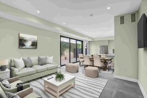 Los Angeles house for rent - A living room with a grey sofa, a coffee table, and a television.