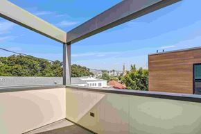 Los Angeles house for rent - A balcony with a view of a building and trees.