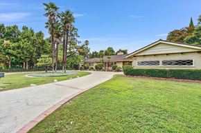 Northridge house for rent - A house with a driveway and a green lawn.