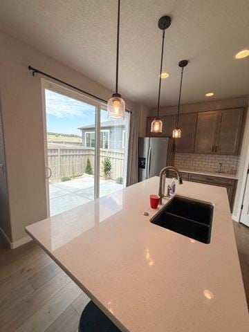 Colorado Springs house for rent - A kitchen with a white countertop and a black sink.