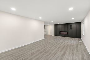 Lithonia house for rent - A spacious room with a fireplace and wood flooring.