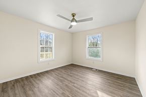 Lithonia house for rent - A room with a ceiling fan and two windows.