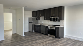 Mandan townhouse for rent - A kitchen with black cabinets and stainless steel appliances.