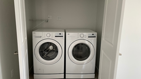Mandan townhouse for rent - Two white front loading washing machines in a small laundry room.