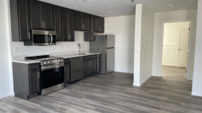 Mandan townhouse for rent - A kitchen with black cabinets and stainless steel appliances.