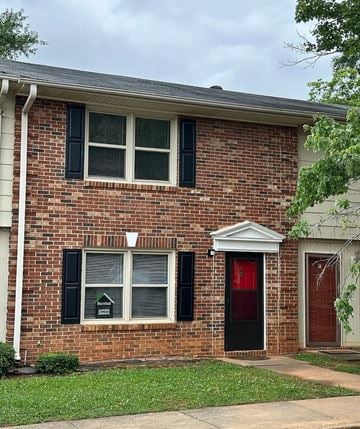Greenville apartment for rent - A red brick house with a black door and a red door.