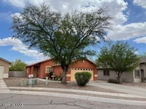 Tucson house for rent - A house with a tree in front of it.