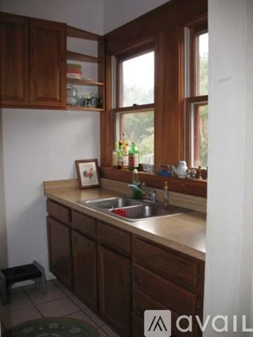 Gainesville apartment for rent - A kitchen with brown cabinets and a window.