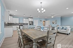 Emerald Isle house for rent - A dining room with a wooden table and chairs.