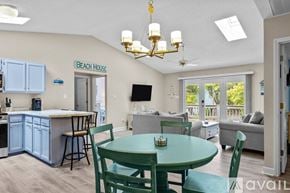 Emerald Isle house for rent - A dining room with a green table and chairs.