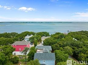 Emerald Isle house for rent - A bird's eye view of a coastal neighborhood with houses and trees.