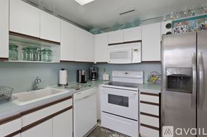 Hollywood apartment for rent - A kitchen with white cabinets and a stainless steel refrigerator.