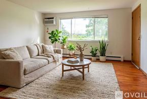 Madison apartment for rent - A kitchen with white appliances and wooden floors.
