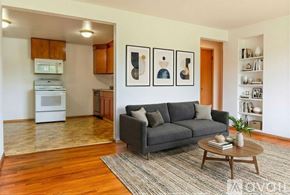 Madison apartment for rent - A room with wooden floors and a window showing trees outside.