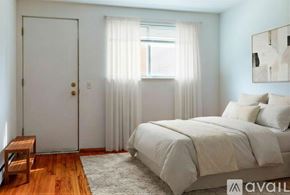 Madison apartment for rent - A room with wooden flooring and a window overlooking trees.