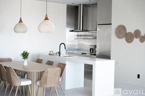 Las Vegas apartment for rent - A modern kitchen with a white table and chairs.