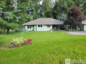 Hailey house for rent - A house with a well-kept lawn and a garden in front.