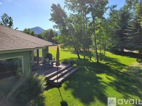 Hailey house for rent - A house with a deck and a mountain in the background.