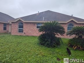Edinburg apartment for rent - A house with a brown roof and a green lawn in front.