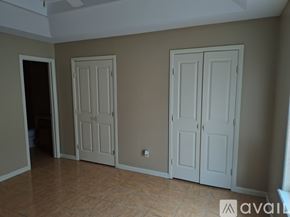 Edinburg apartment for rent - A room with two white doors and a tiled floor.